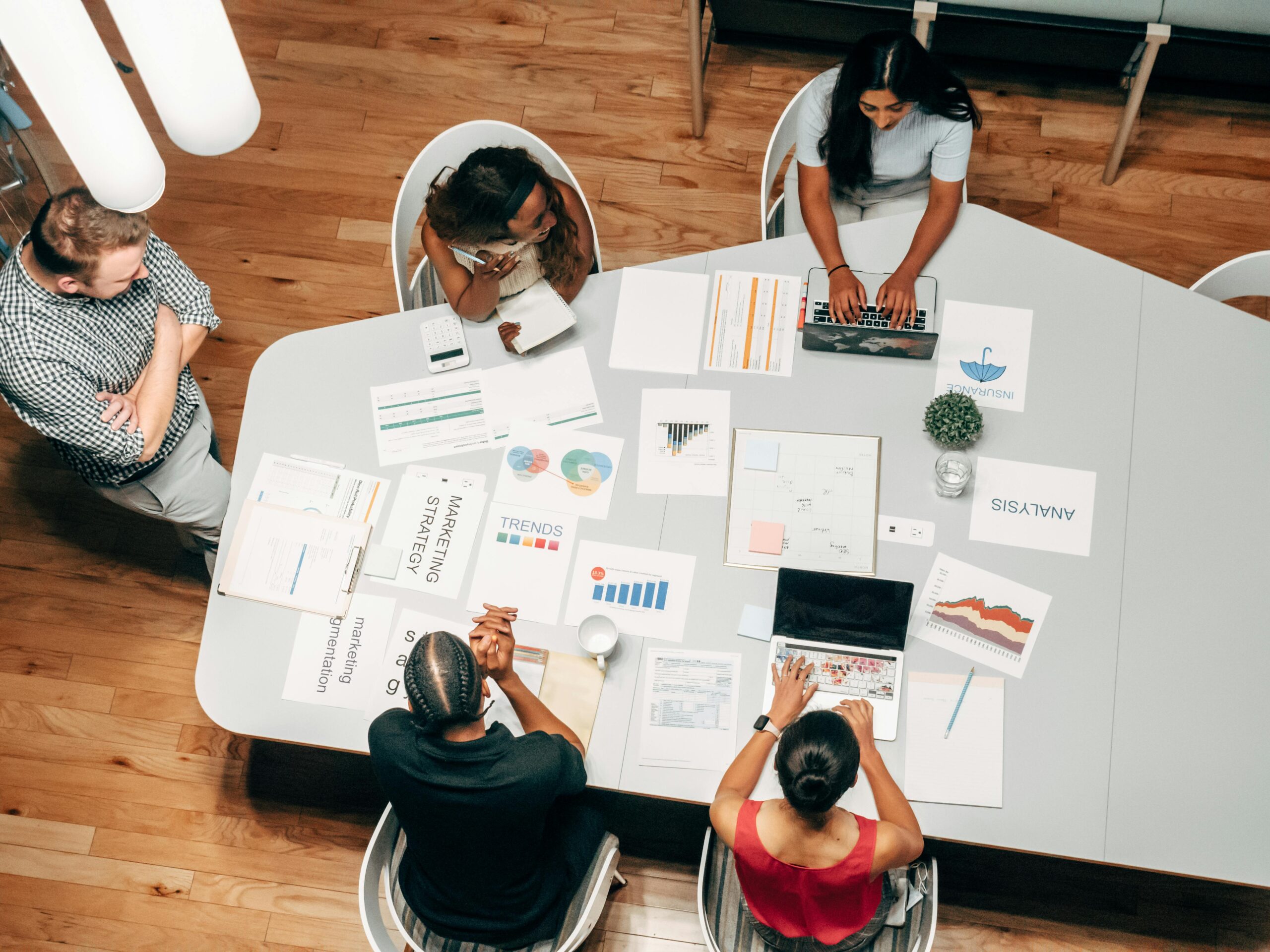 Team collaborating in a meeting, discussing digital marketing strategies and SEO techniques.